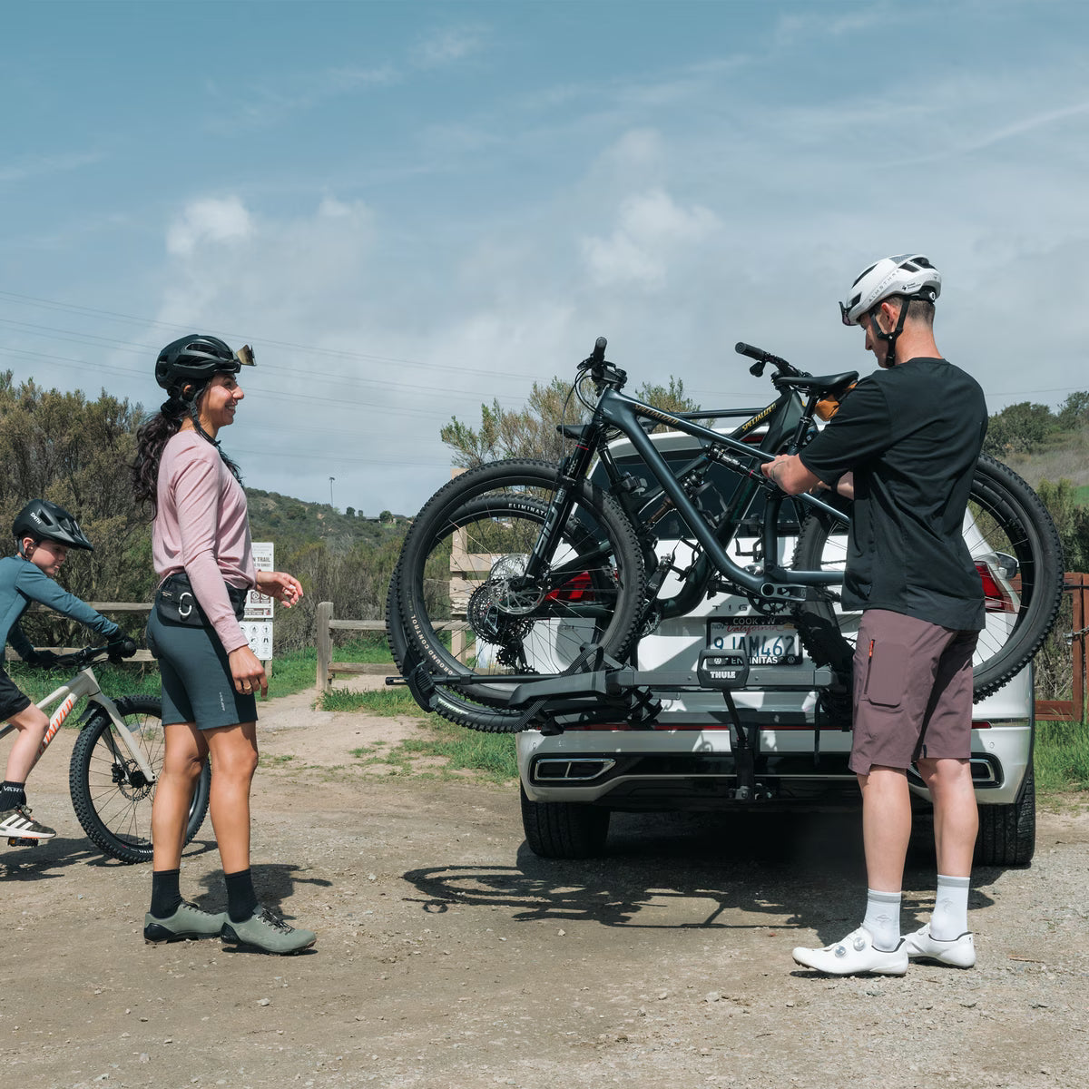Deux cyclistes chargeant leurs vélos sur le porte-vélos Thule Outpace 2 vélos avant une sortie sur les sentiers