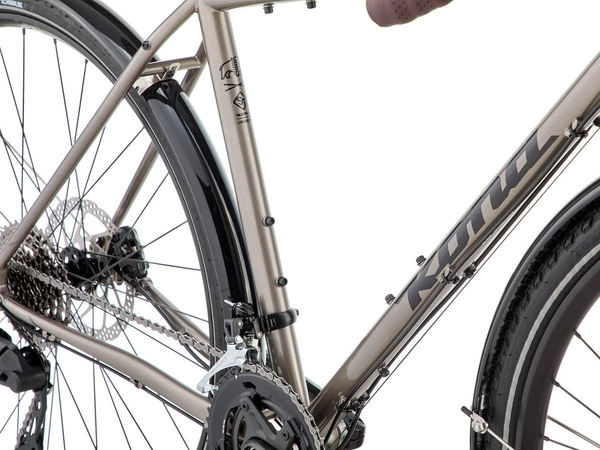Gros plan de la transmission Shimano CUES 10 vitesses du Kona Sutra, avec pédalier double 32/46 dents pour grimper chargé sans forcer.